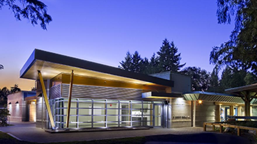 Exterior of Al Anderson Pool. There is a well-lit, modern building.