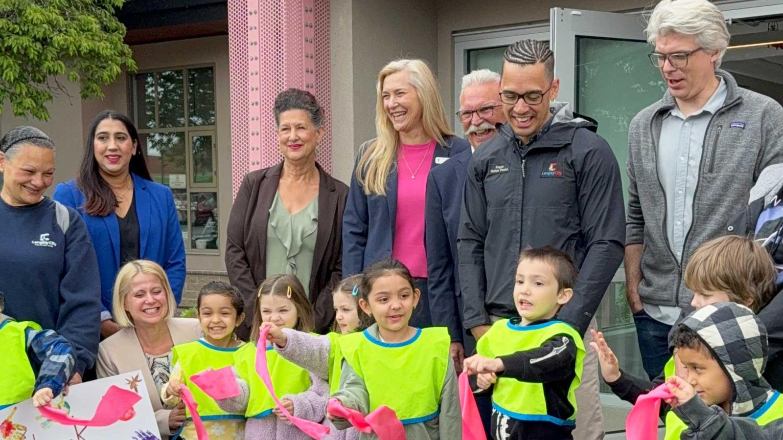 Photo of Douglas Recreation Child Care Centre Children; Susie Bowden, Langley City Early Years Education Instructor; Judy Toor, MLA; Rosemary Wallace, Langley City Councillor; Heidi Worthington, President & CEO of YMCA BC; Paul Albrecht, Langley City Councillor; Nathan Pachal, Langley City Mayor; Andrew Mercier, Minister of State for Workforce Development,