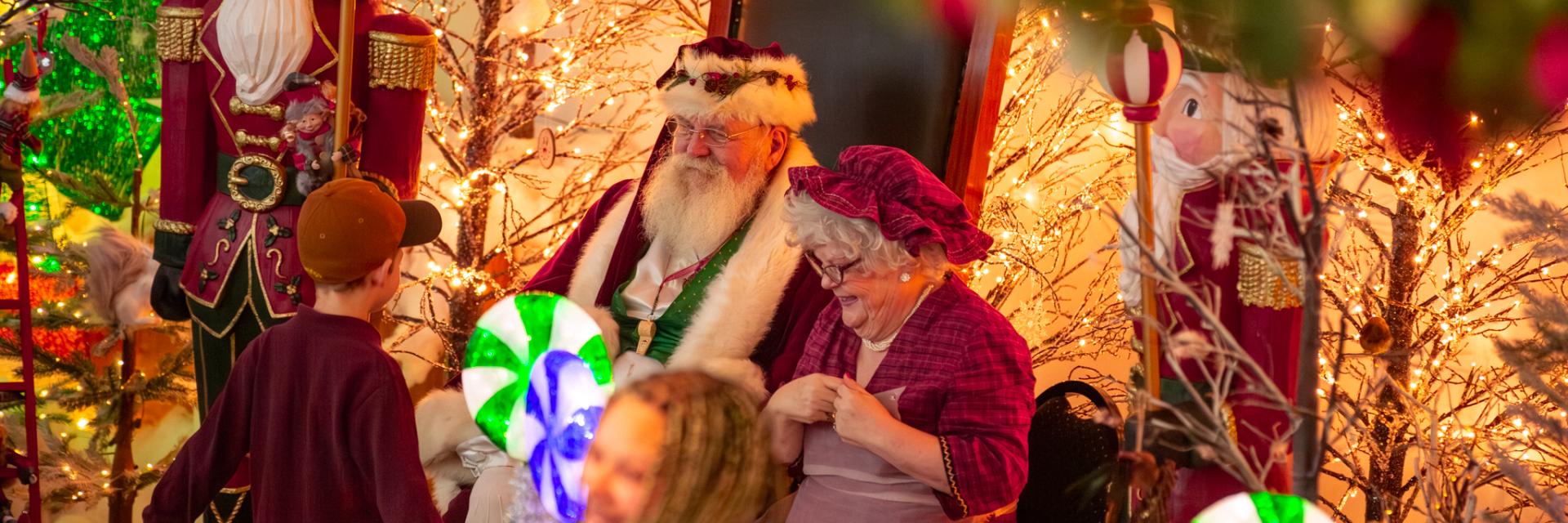 Santa and Mrs. Claus speaking with a child