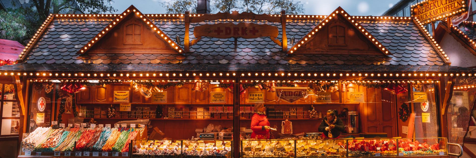 Outdoor Christmas Market vendor stalls with a variety of gifts.