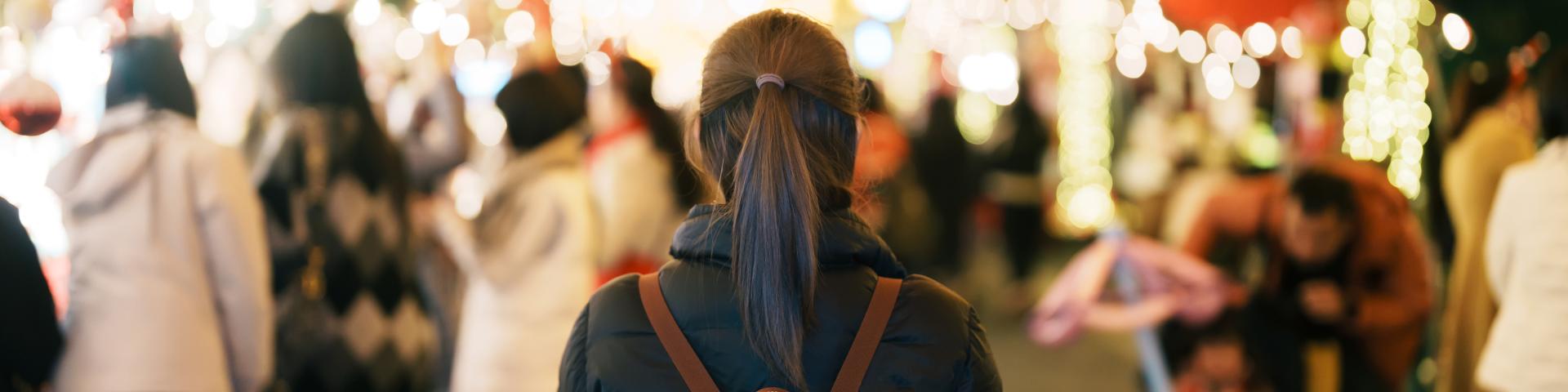 young girl shopping at a Christmas market