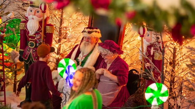 Santa and Mrs. Claus speaking with a child