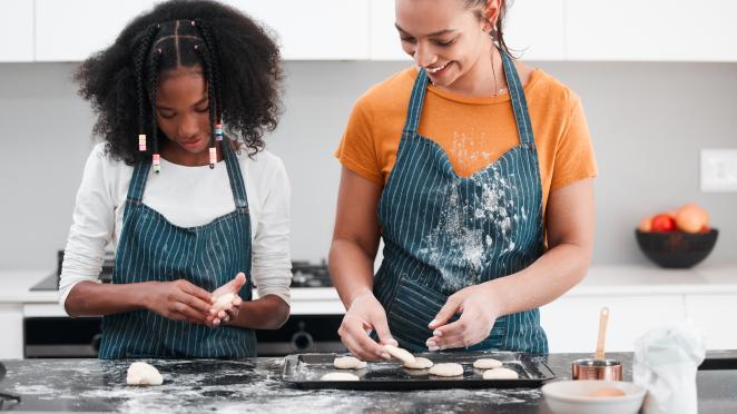 Two teenage girls baking.