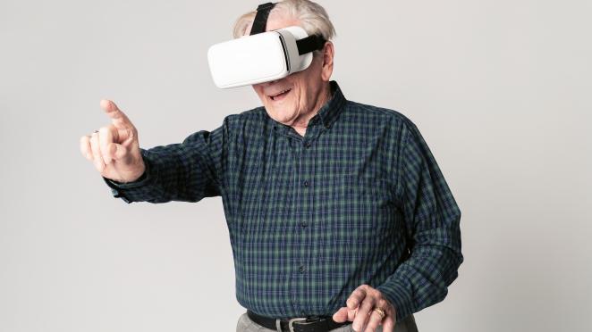 senior man wearing virtual reality goggles