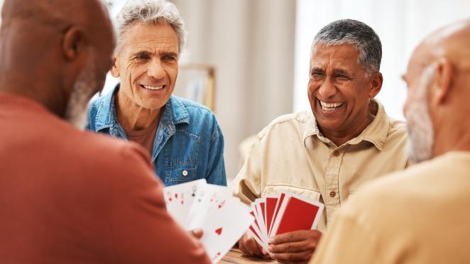 happy seniors playing card game