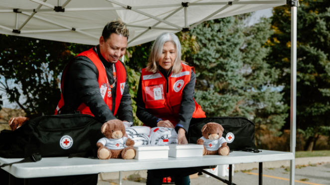volunteers helping at a Canadian Red Cross table