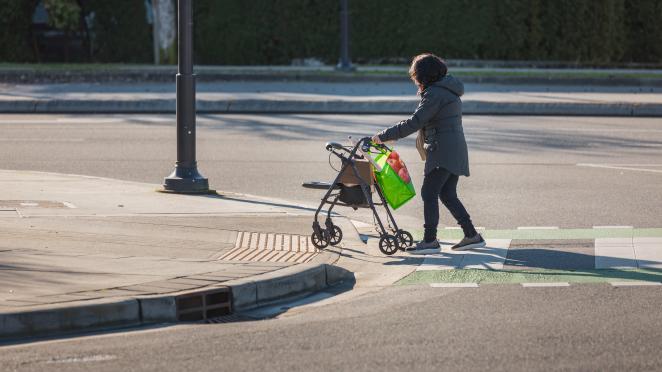 women with walker crossing the street