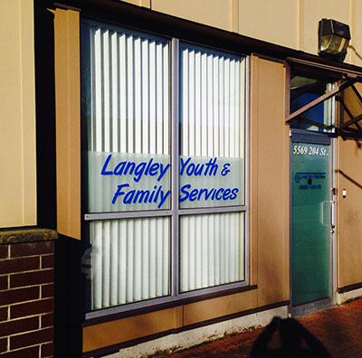 Window of building that says Langley Youth and Family Services
