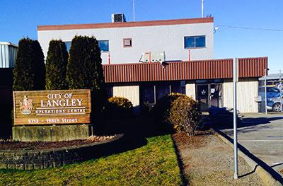 Two story building in the sun with City of Langley Operations Center sign in front.